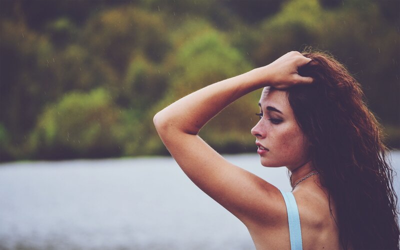 woman with wet hair by water