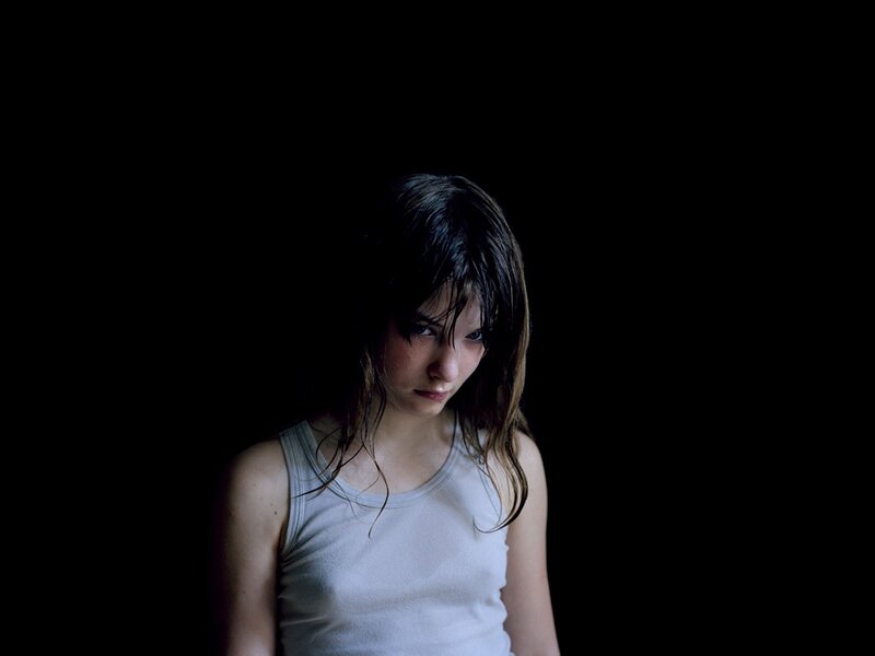 woman with wet hair in dark room