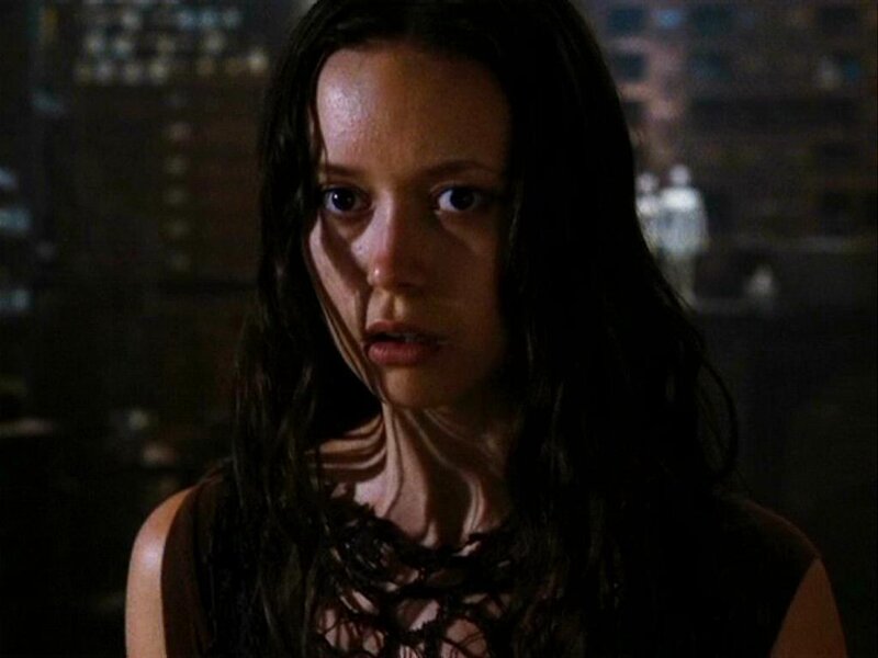 woman with wet hair in dark room
