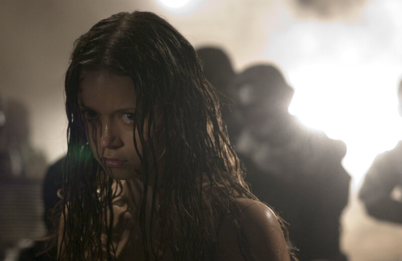 woman with wet hair in dark room