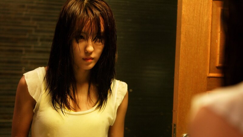 woman with wet hair in dim light
