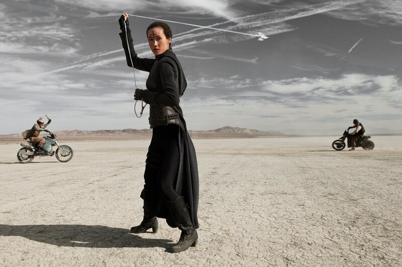 Woman with whip in desert