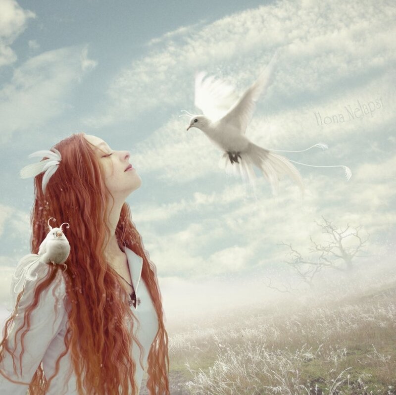 woman with white birds in field
