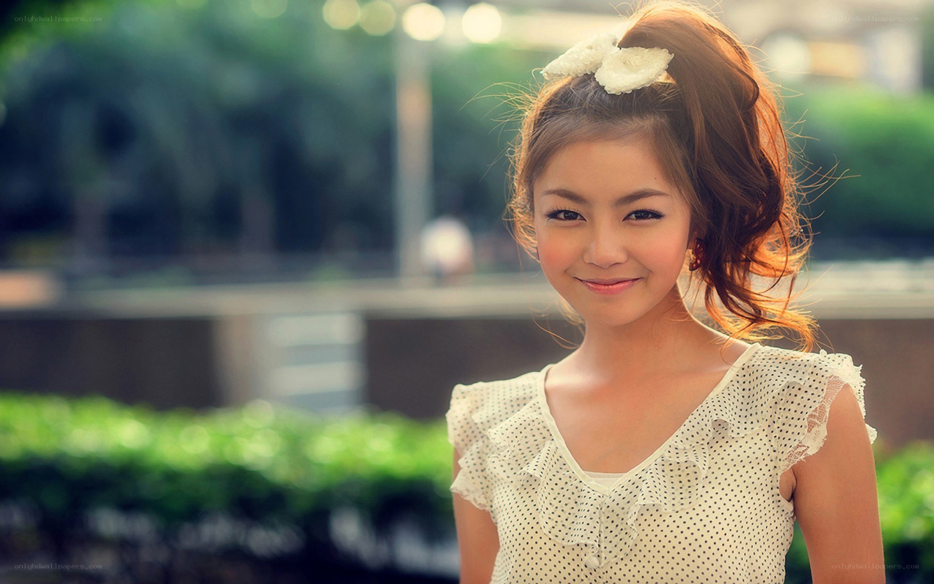 woman with white bow smiling