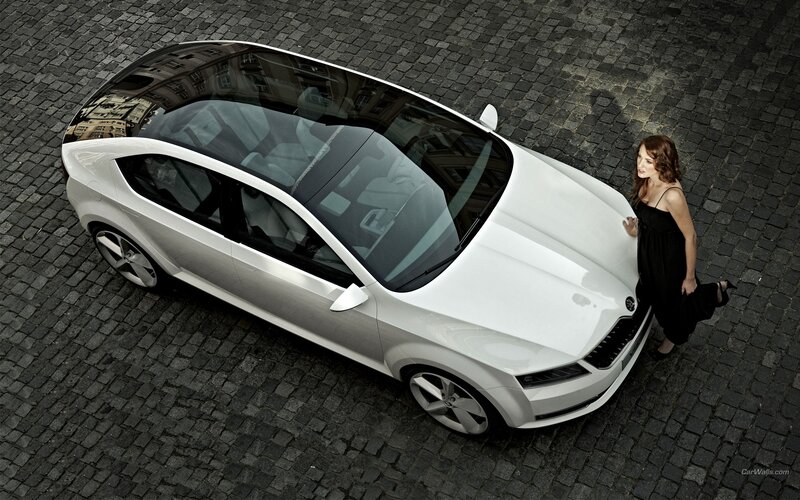Woman with white car on cobblestones
