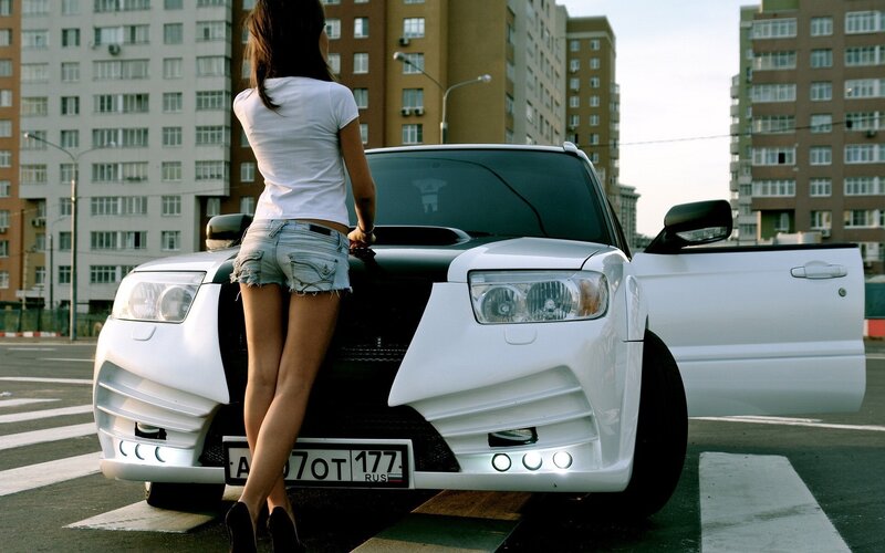 Woman with white car on street