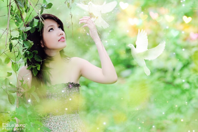 woman with white doves in garden