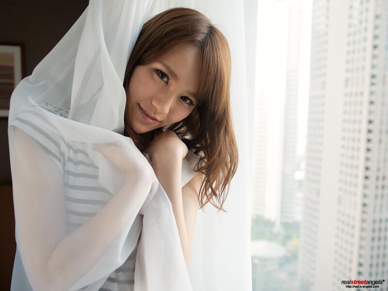woman with white fabric near window