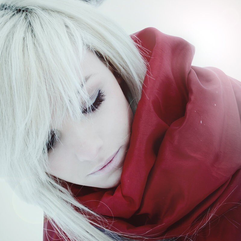 woman with white hair and red scarf