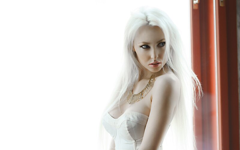 woman with white hair by window
