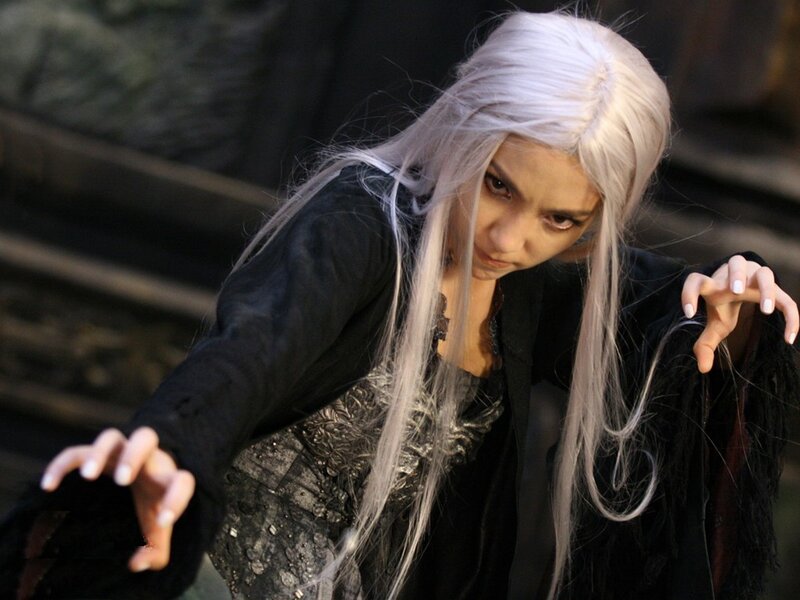 woman with white hair in dark costume
