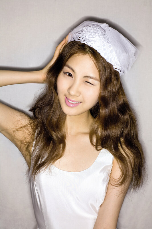woman with white headband smiling