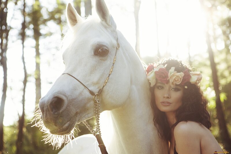 woman with white horse in forest