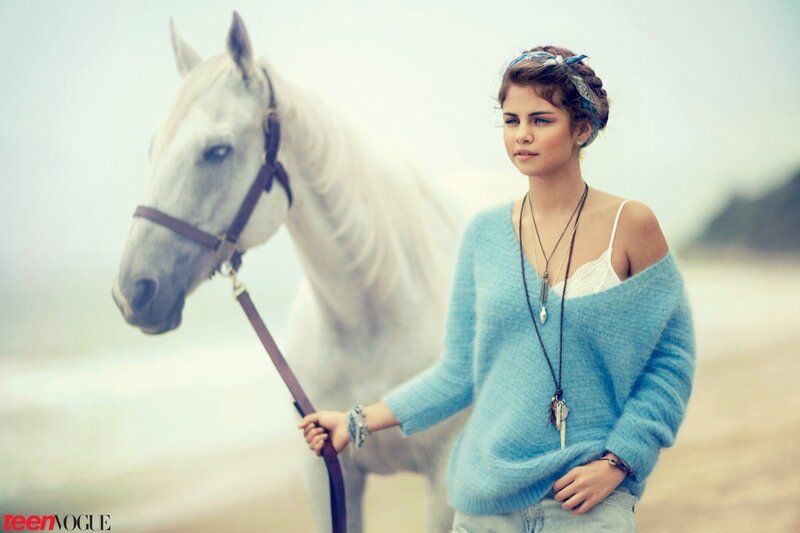 woman with white horse on beach