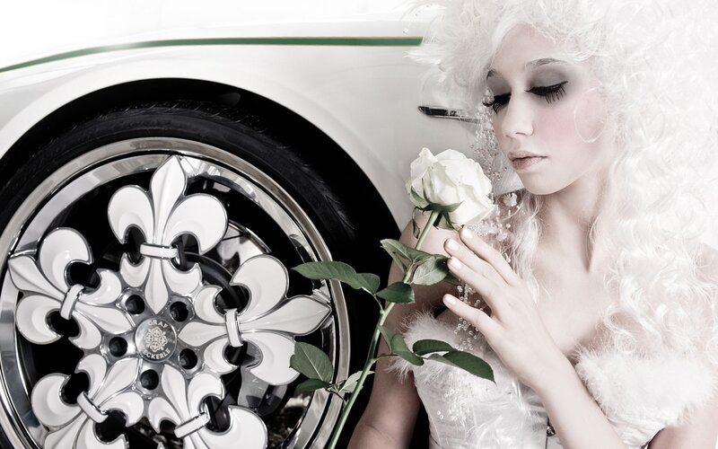 woman with white rose and car wheel