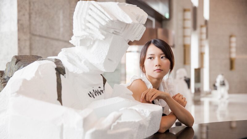 Woman with white sculpture