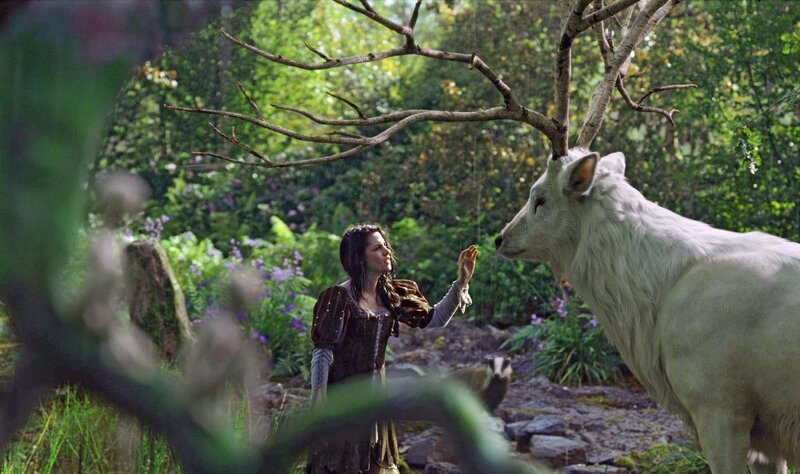 woman with white stag in forest