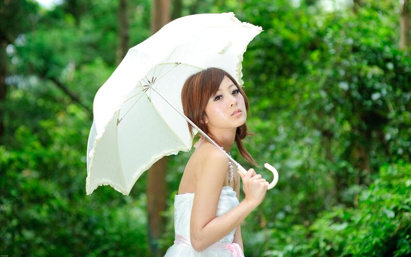 woman with white umbrella in park