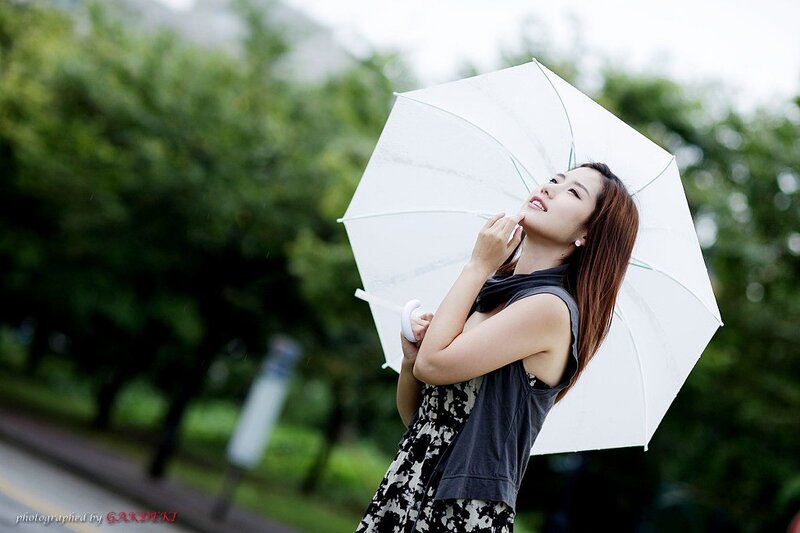 woman with white umbrella in rain