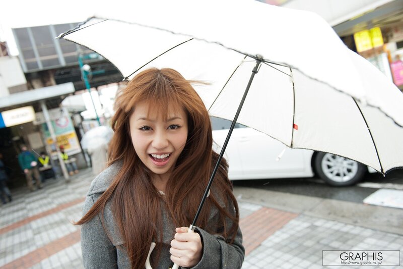 Woman with white umbrella on street
