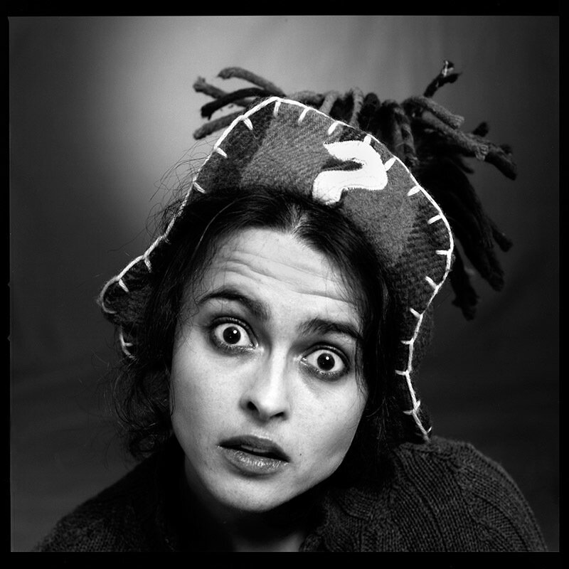 woman with wide eyes and hat