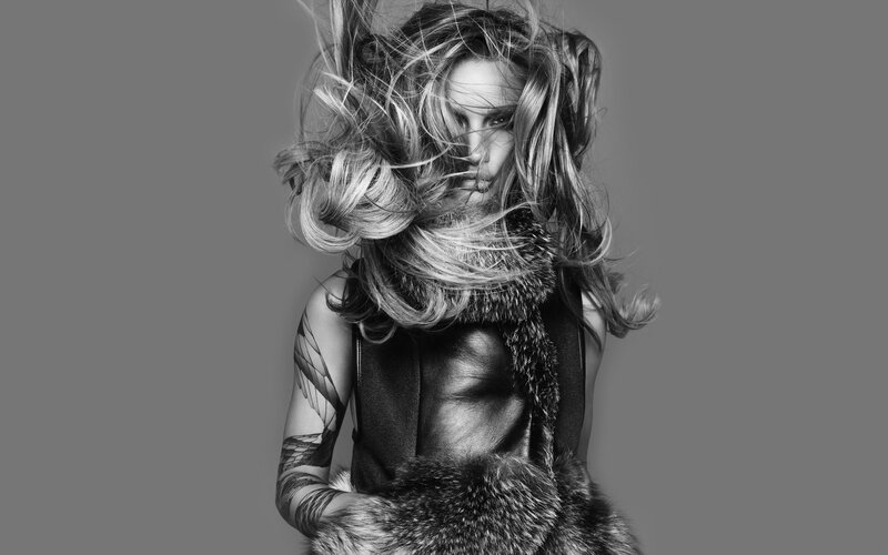 woman with wild hair and fur vest
