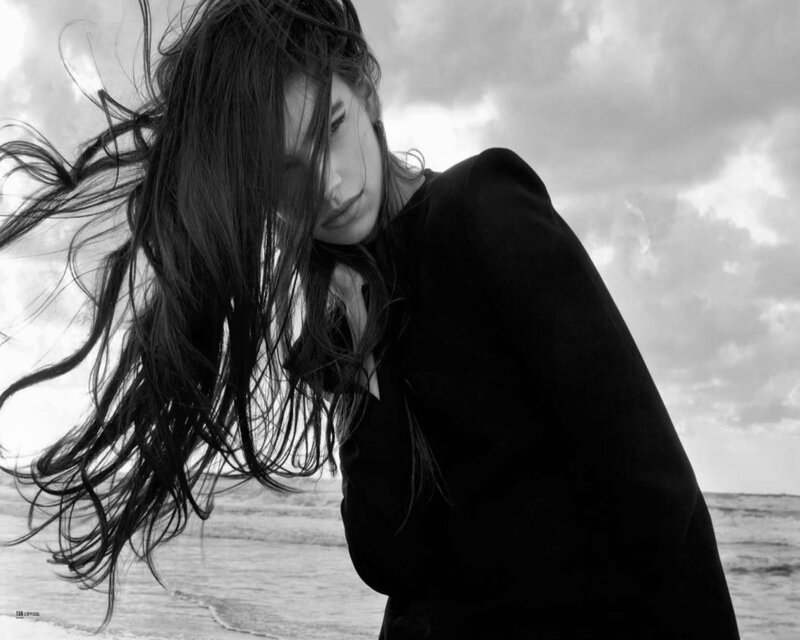woman with wind-blown hair at beach