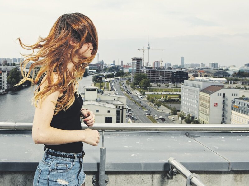 Woman with wind-blown hair on a rooftop