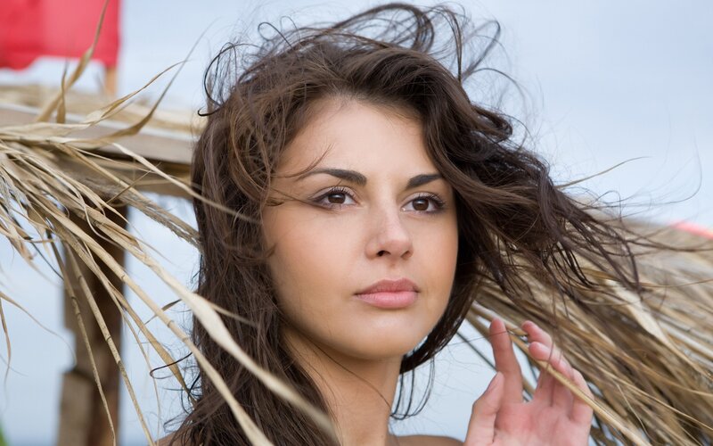 woman with windblown hair at beach