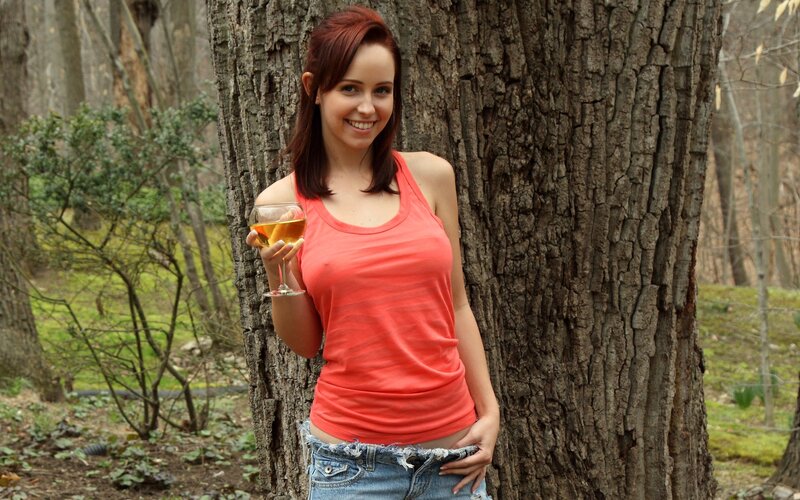 Woman with wine in forest