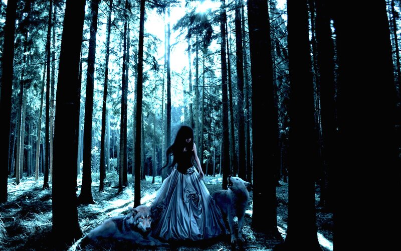 woman with wolves in forest