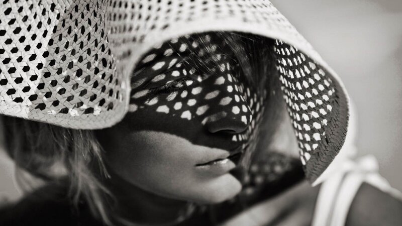 woman with woven hat shadow