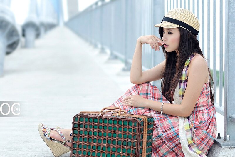woman with woven suitcase