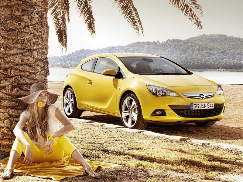 Woman with yellow car by palm tree