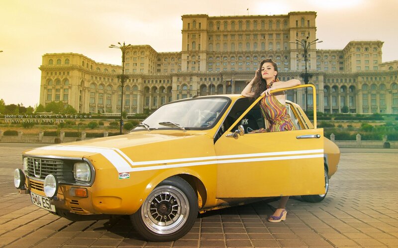 Woman with yellow car in front of palace