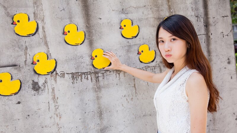 Woman with yellow duck wall art