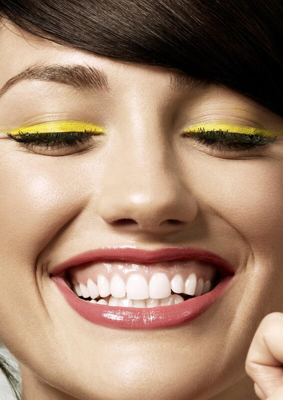 woman with yellow eyeliner smiling