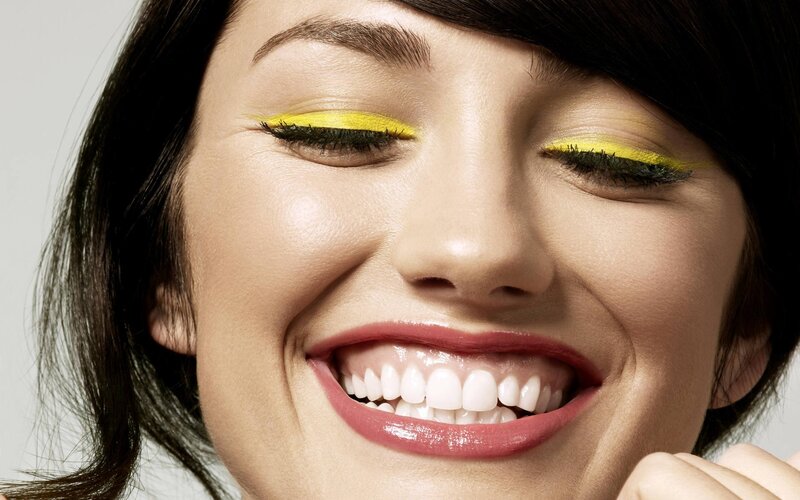 woman with yellow eyeshadow smiling
