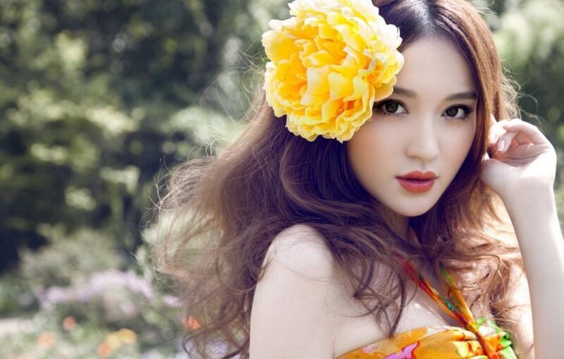 woman with yellow flower in hair