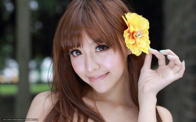 Woman with yellow flower in hair