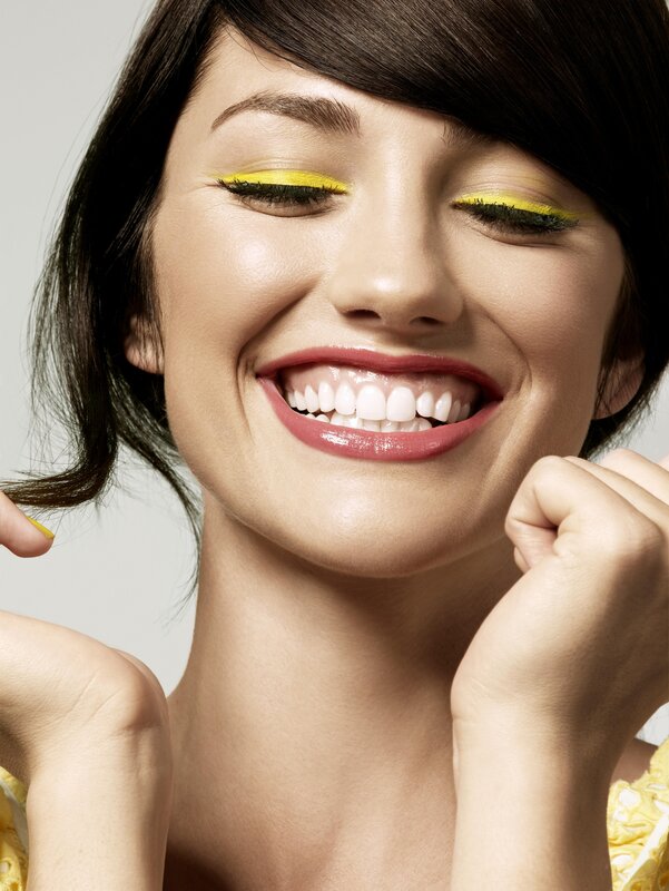 woman with yellow makeup smiling