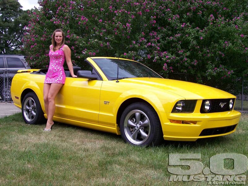 Woman with yellow Mustang convertible