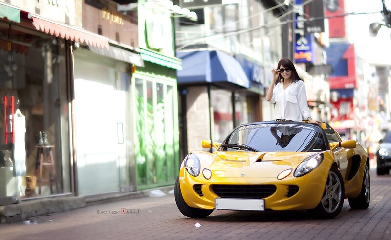 Woman with yellow sports car