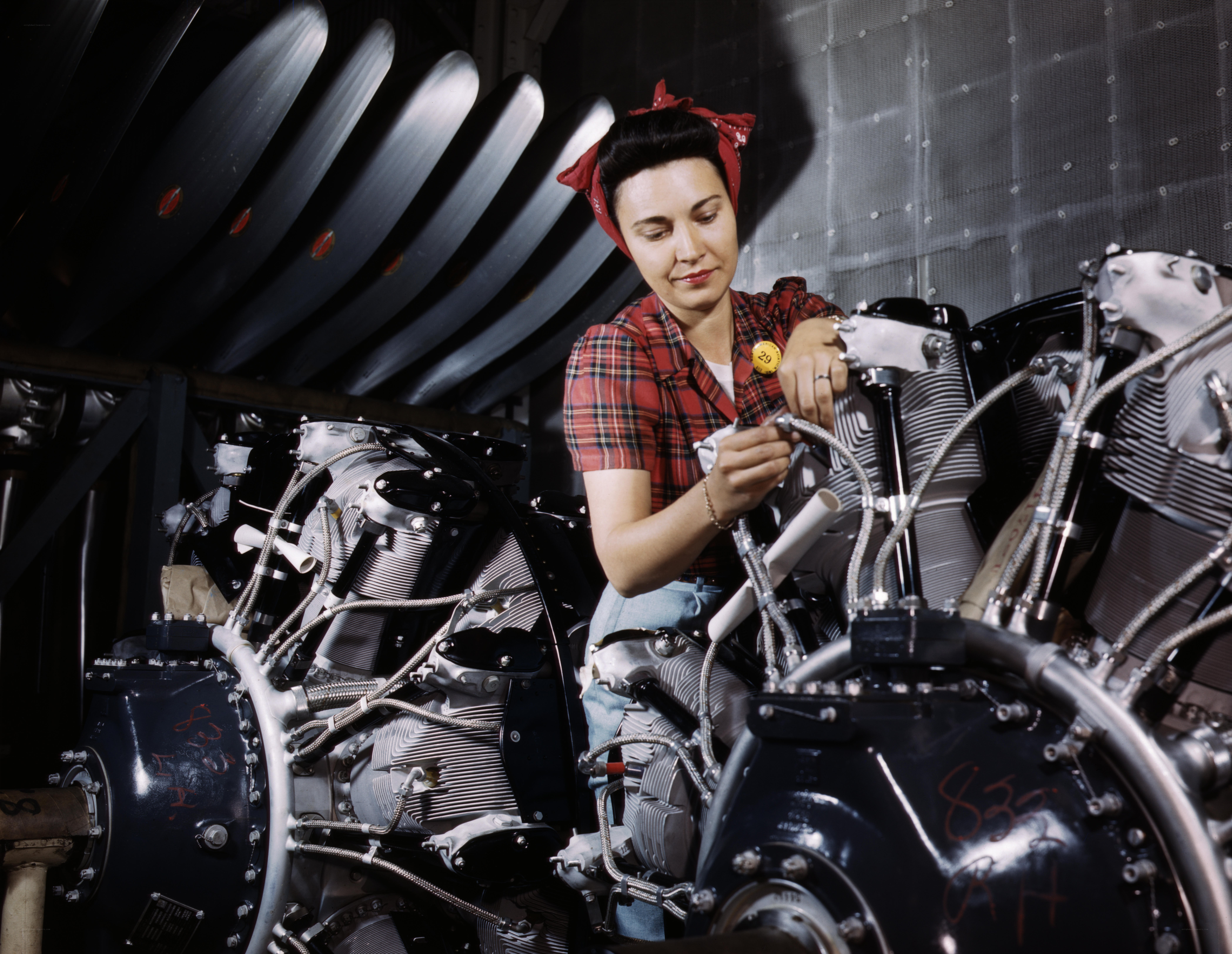 Woman working on aircraft engine