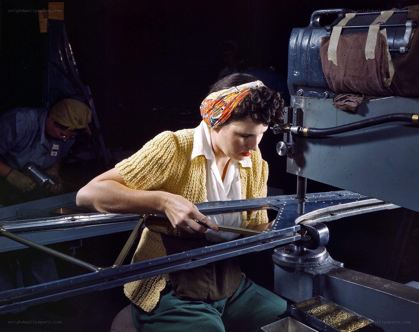 Woman working on aircraft frame