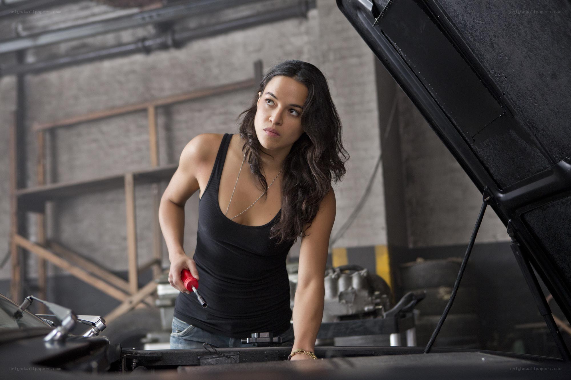 woman working on car engine