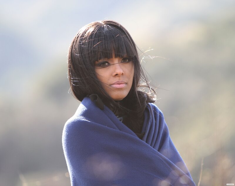 woman wrapped in blue shawl