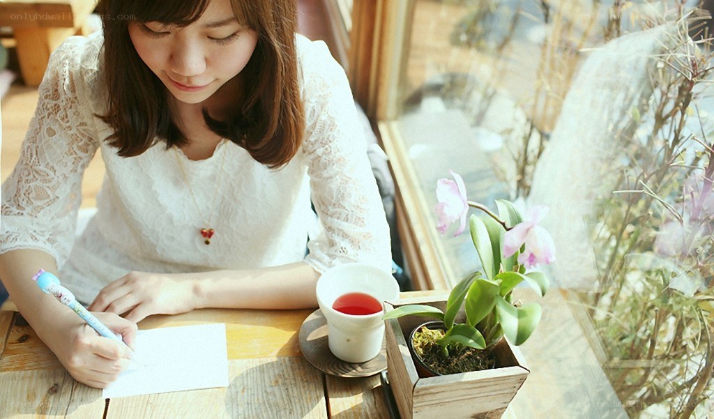 woman writing at a table
