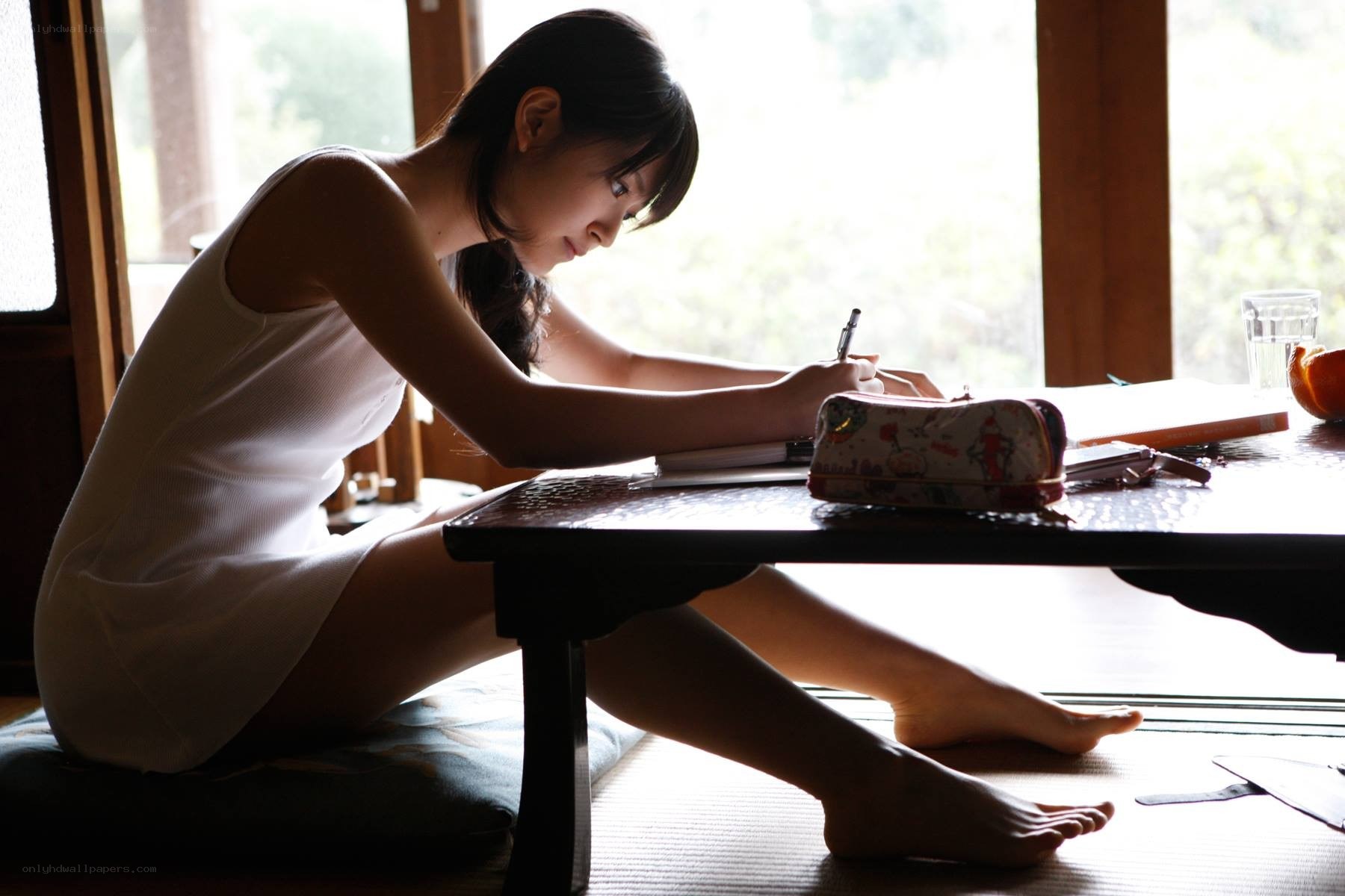 woman writing at a table