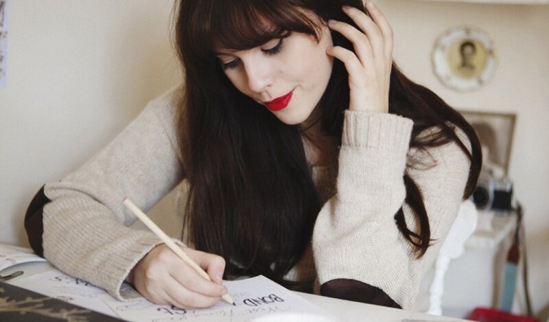 woman writing at desk
